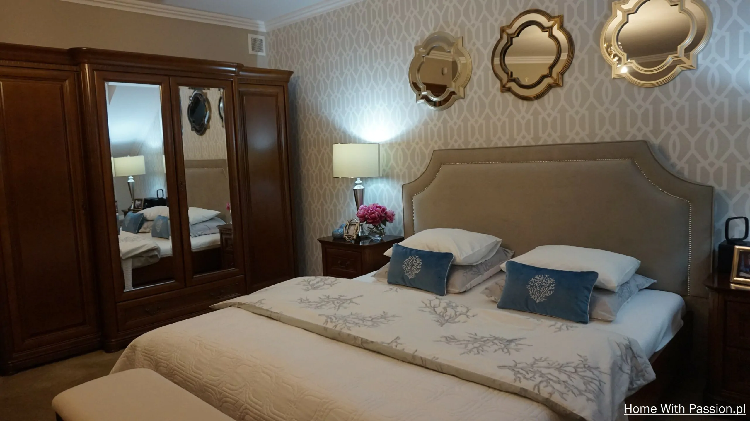 elegancka sypialnia z dużą szafą drewnianą, łóżko z zagłówkiem tapicerowanym i dekoracyjne lustra na ścianie